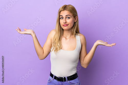 Young Uruguayan blonde woman over isolated background making doubts gesture