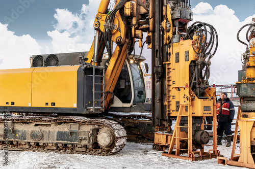 A powerful drilling rig for piling in winter at a construction site. Operation of the drilling rig in northern conditions. Pile foundations. Bored piles. Close-up.