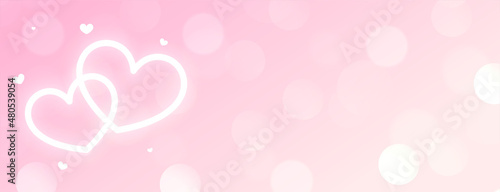 beautiful two neon glowing white hearts on pink bokeh background