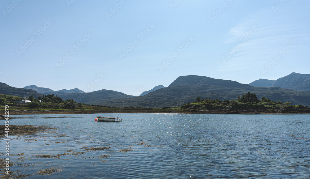 Torridon Loch view with a small boat floating. 