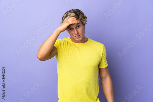 English man over isolated purple background with headache