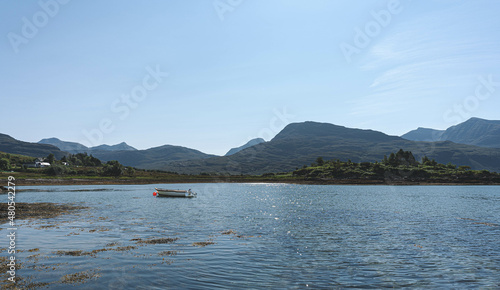 Torridon Loch view with a small boat floating. 
