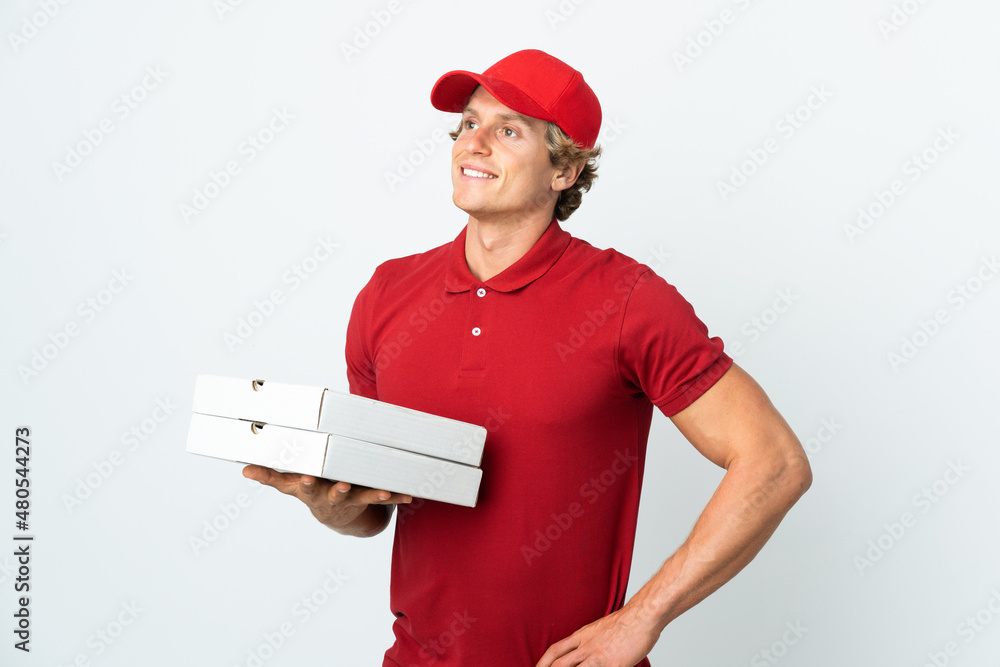 pizza delivery man over isolated white background posing with arms at hip and smiling pizza delivery man over isolated white background posing with arms at hip and smiling