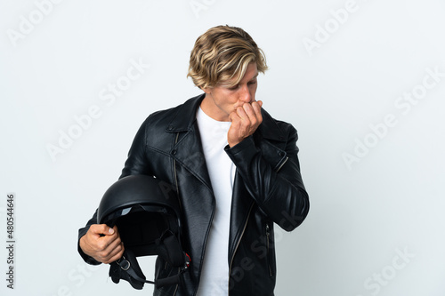 English man holding a motorcycle helmet having doubts