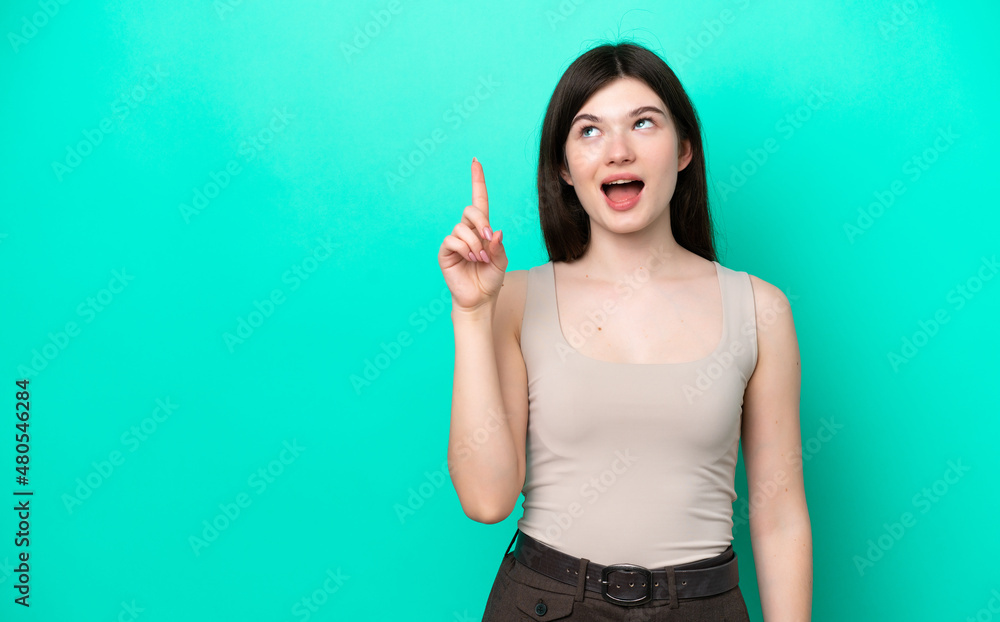 Young Russian woman isolated on green background intending to realizes the solution while lifting a finger up Young Russian woman isolated on green background intending to realizes the solution while lifting a finger up