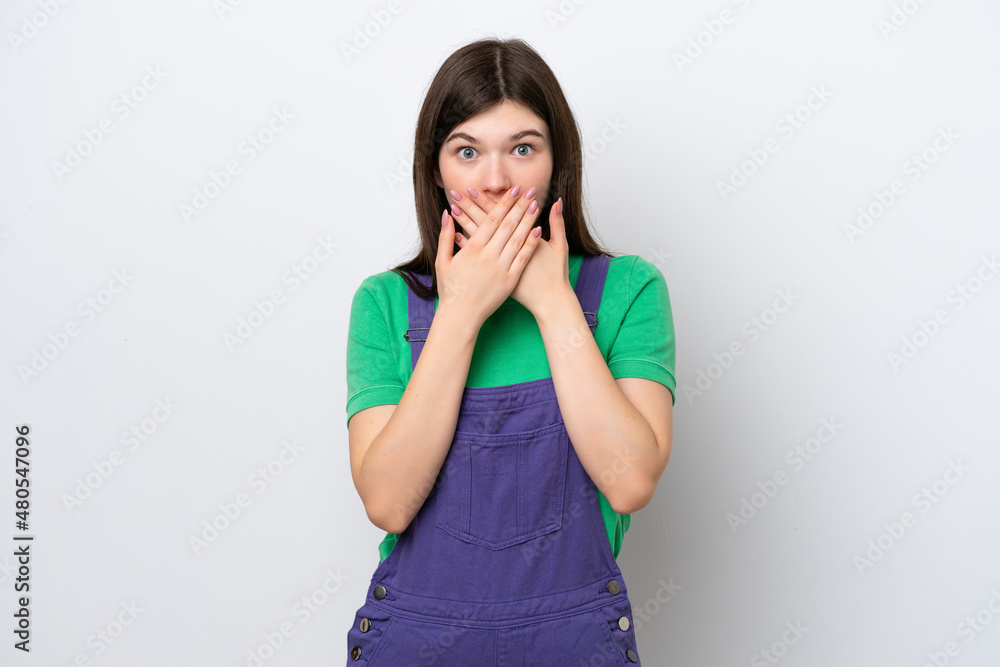 Young Russian woman isolated on blue background covering mouth with hands Young Russian woman isolated on blue background covering mouth with hands