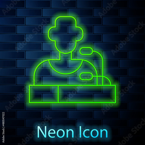 Glowing neon line Football player press conference icon isolated on brick wall background. Vector