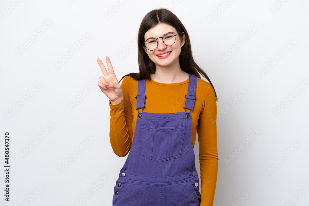 Young Russian woman isolated on blue background smiling and showing victory sign Young Russian woman isolated on blue background smiling and showing victory sign