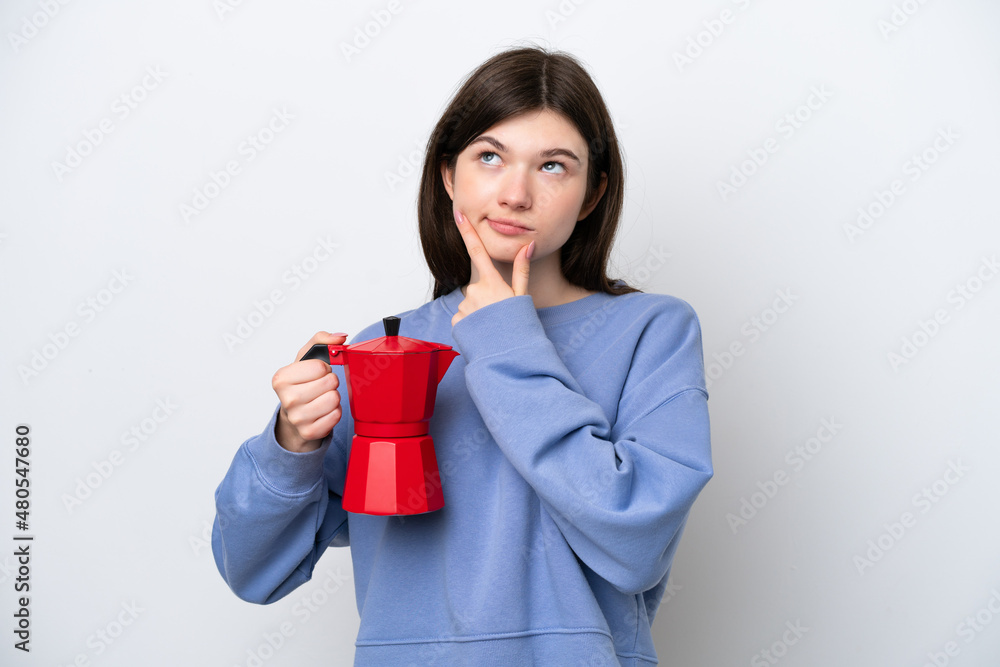 Young Russian woman holding coffee pot isolated on white background having doubts Young Russian woman holding coffee pot isolated on white background having doubts