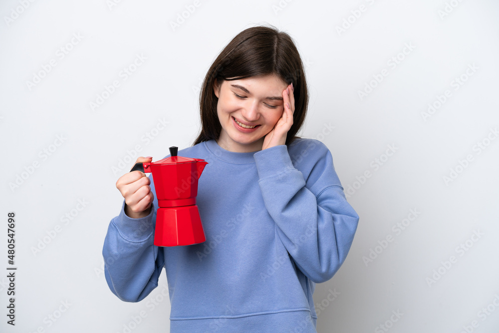 Young Russian woman holding coffee pot isolated on white background laughing Young Russian woman holding coffee pot isolated on white background laughing