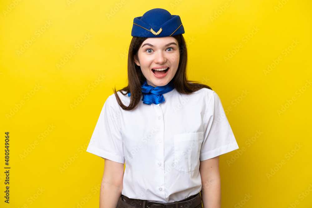 Airplane stewardess Russian woman isolated on yellow background with surprise facial expression Airplane stewardess Russian woman isolated on yellow background with surprise facial expression