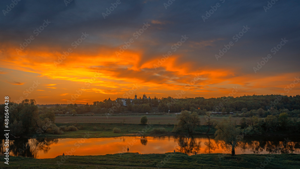 Wide angle view of Moscow river and Savvino-Storozhevskiy Monastyr' (Convent) with dramatic clouds at autumn sunset 