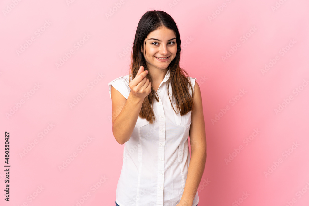 Young caucasian woman isolated on pink background making money gesture Young caucasian woman isolated on pink background making money gesture
