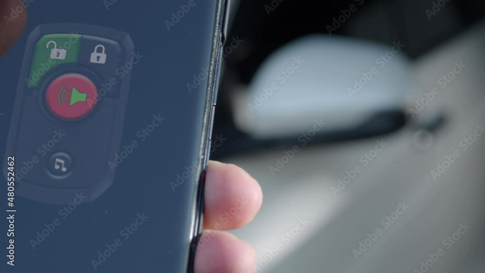 Unlock and lock Car Using Smartphone App. Man hand Unlocking car by use