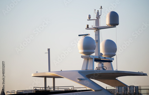 Closeup view of navigation radar system antennas yacht on blue sky background