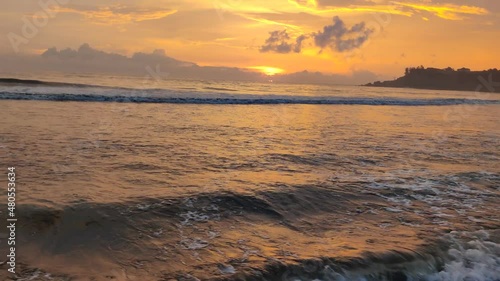 Orange sunset view over the sea waves at the evening from Bekal beach
