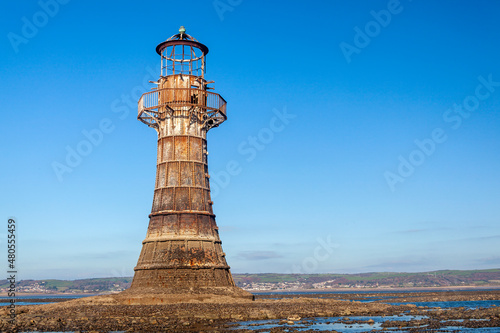 Whitford Lighthouse a cast iron Victorian ruin on the north coast of the Gower Peninsular South Wales UK which is a popular tourist holiday travel destination and landmark attraction, stock photo 
