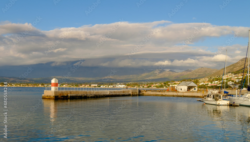 Fototapeta premium Gordons Bay harbour, nestled beneath the Hottentots Holland Mountains, located in the Cape province near Cape Town in South Africa
