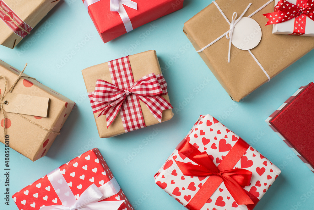 Obraz premium Top view photo of st valentine's day decorations presents gift boxes on isolated pastel blue background