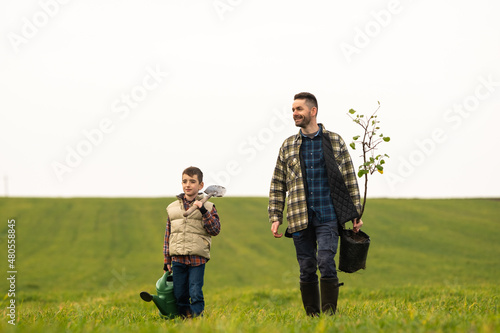 The handsome man and his son working in the field