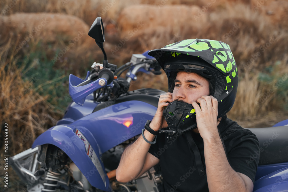 Man taking off his motorcycle helmet