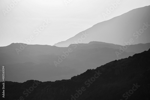 Beautiful Black and white beautiful layered effect landscape image across Lake District mountains