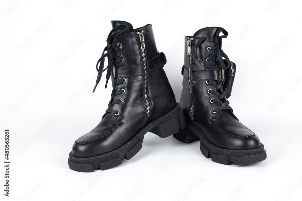 Black winter boots for young girls, teenagers on a white background with a light shade, shoes with insulation inside and do not get wet. The boots have a small purse for money or keys Black winter boots for young girls, teenagers on a white background with a light shade, shoes with insulation inside and do not get wet. The boots have a small purse for money or keys