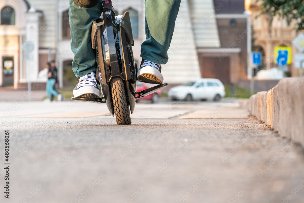 Foto de The beginning of riding an electric unicycle (EUC) do Stock