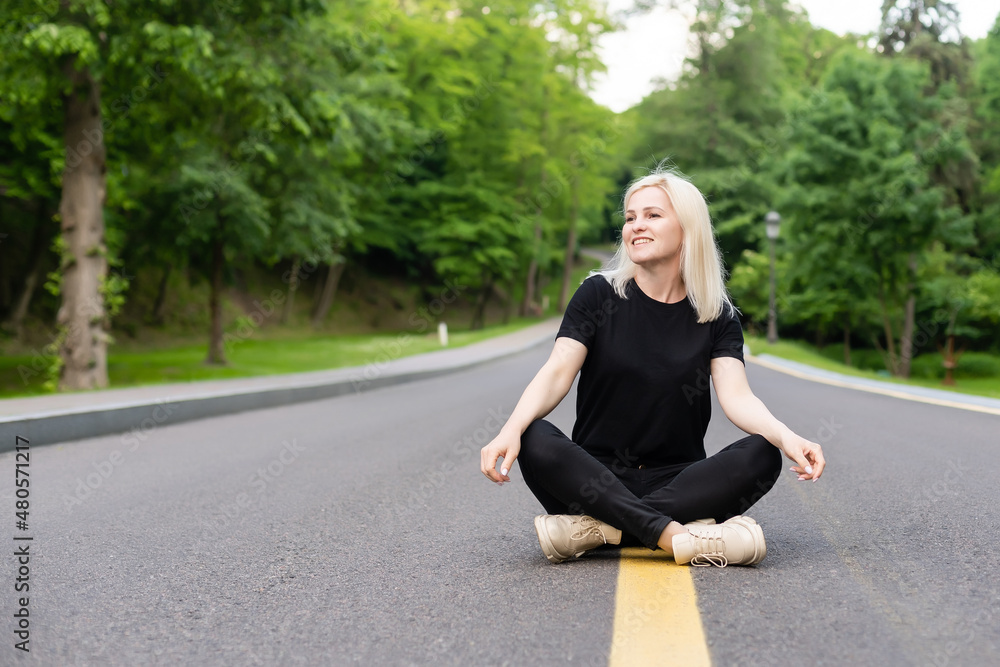 Attractive young woman walks along the line of the road enjoying nature. Attractive young woman walks along the line of the road enjoying nature.