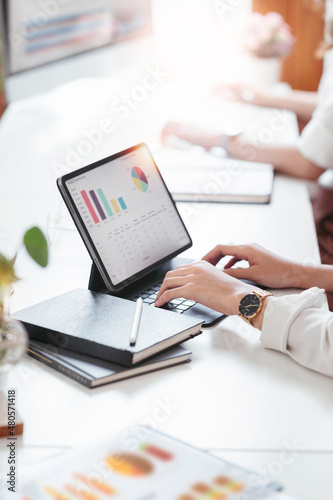 Business people team working at office with tablet and document, doing planning analyzing the financial report, business plan investment, finance analysis concept. Economic business discussions.