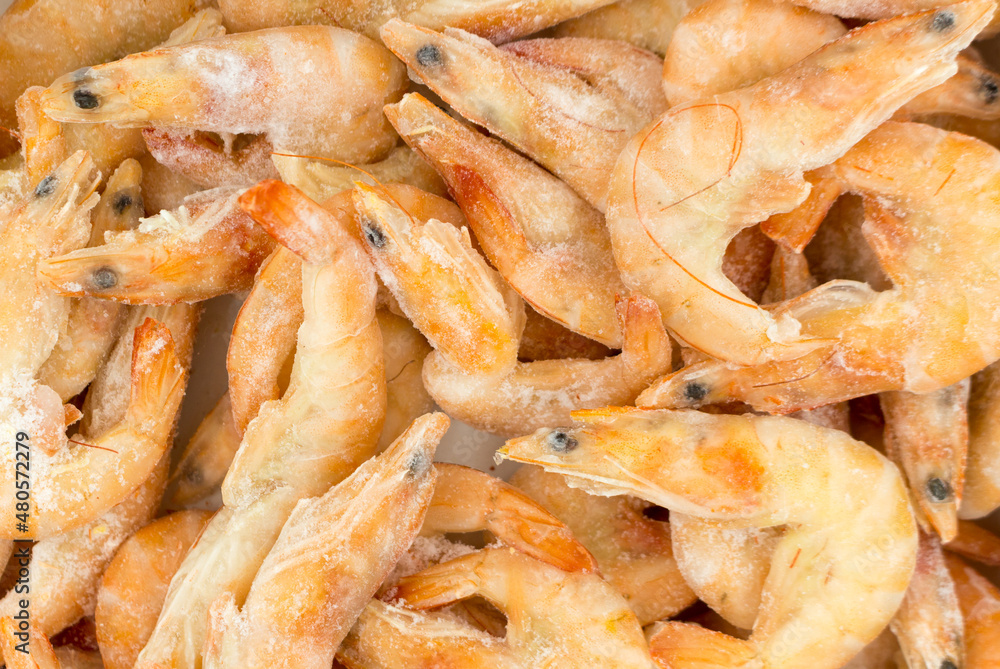 Fresh, raw shrimps on ice. Frozen product for cooking. Fresh, raw shrimps on ice. Frozen product for cooking.