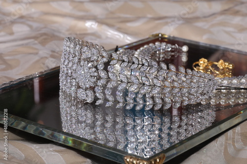 diamond studded tiara or stone crown on a mirror tray
