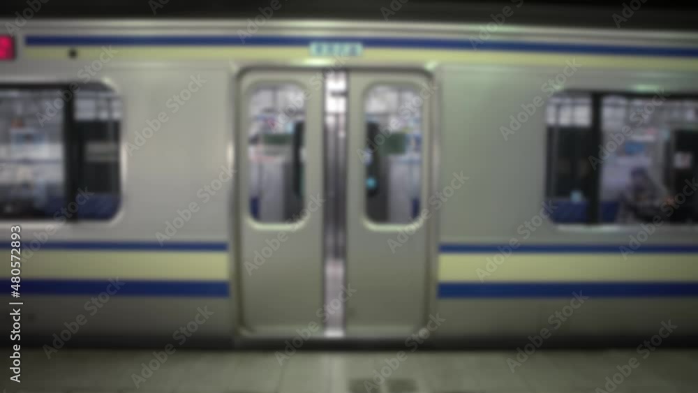 Defocused shot of train door closed on platform Railway in Tokyo, Japan. Asia Metro. Subway underground station, fast transportation and Asian commuters. Blurred background in the scene Defocused shot of train door closed on platform Railway in Tokyo, Japan. Asia Metro. Subway underground station, fast transportation and Asian commuters. Blurred background in the scene