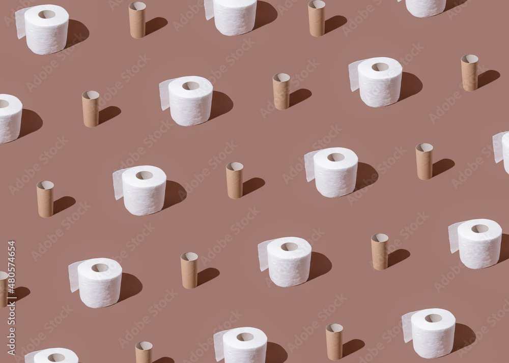 Toilet paper rolls on brown background. Stomach upset. Toilet paper rolls pattern. Global Corona virus pandemic. Isolation mood. WC minimalism. Flat lay. Bathroom minimal concept.  
