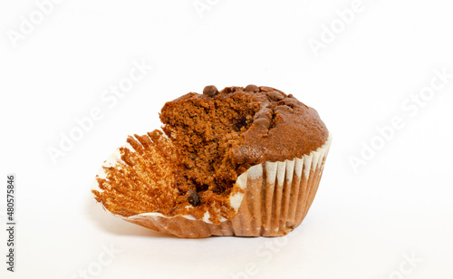 a chocolate chip corn muffin, half bitten, isolated on a white background