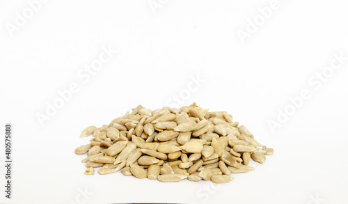 a pile of raw sunflower seeds isolated on a white background