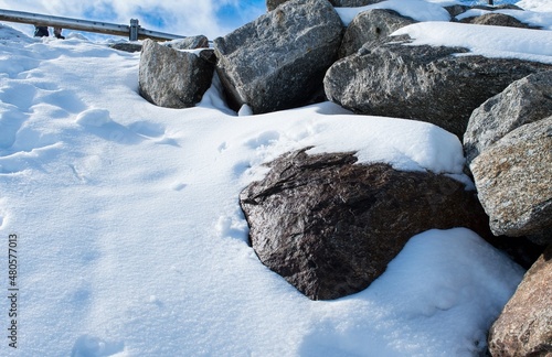 Rough, thick and large rocks in thick snow photo