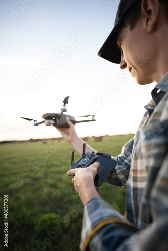 Farmer with drone on a field. Smart farming and precision agriculture