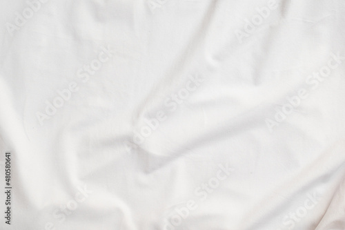 Closeup rippled soft white fabric texture background.