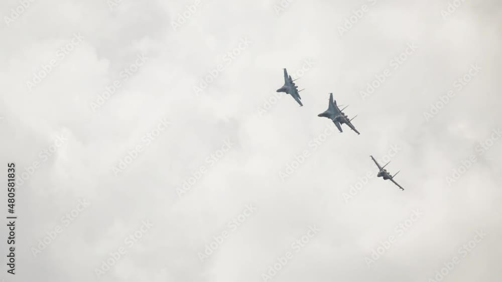 Group of military fighters perform aerobatics overhead. Military aviation. Russian jet military aircraft Flanker-E at airshow. Fighting falcon