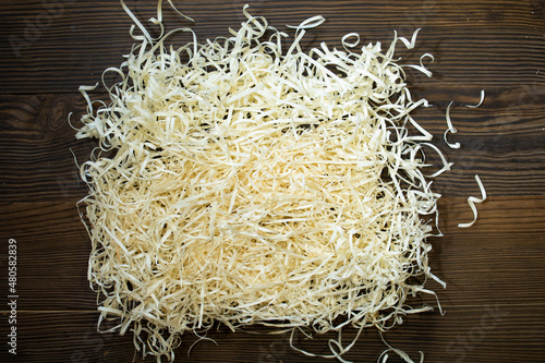 A bunch of large sawdust and shavings. Abstract textured background on wooden background