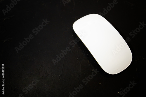 touch white computer mouse on a black background