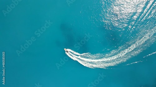 overhead view of boat in blue sea water wakesurfing photo