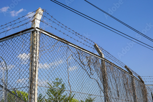 The walls of the building are made of concrete with sharp and sharp barbed iron wire at the top.
