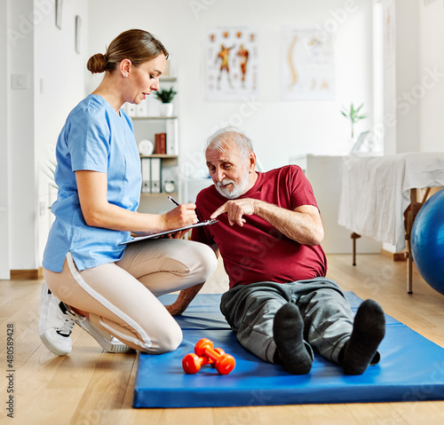 nurse doctor senior care exercise physical therapy exercising help assistence retirement home physiotherapy strech band clinic therapist elderly man