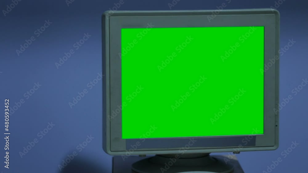 Portrait of professional surgeons using medical instruments in operating room during surgery. Specialists working during operation surgery looking at monitor with green screen 