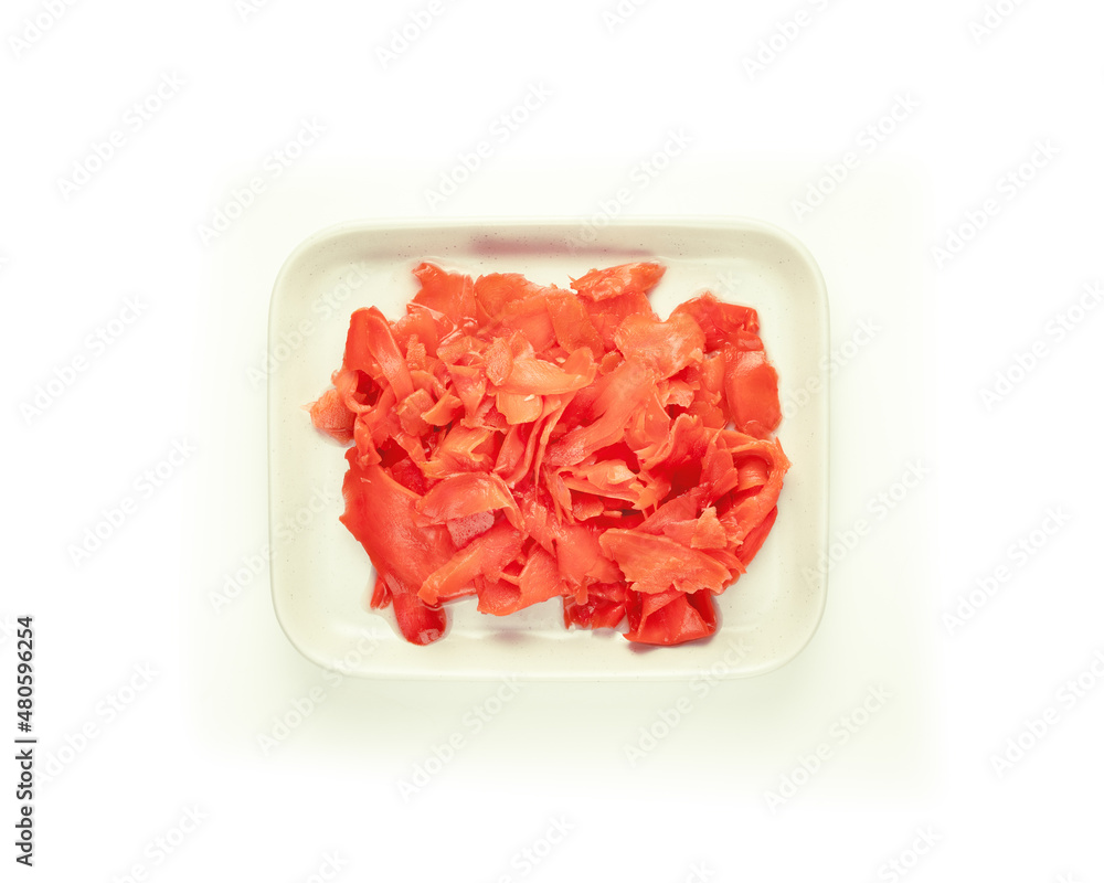 Isolated red pickled ginger on a white porcelain plate on a white background. Natural ingredient of Oriental cuisine. A product that increases immunity. Flat lay Isolated red pickled ginger on a white porcelain plate on a white background. Natural ingredient of Oriental cuisine. A product that increases immunity. Flat lay