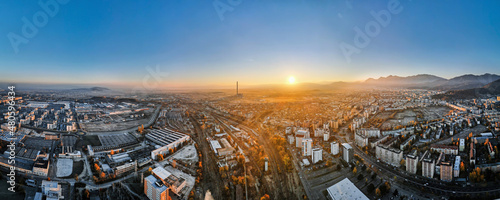 Aerial drone panoramic view of Brasov at sunrise, Romania © frimufilms