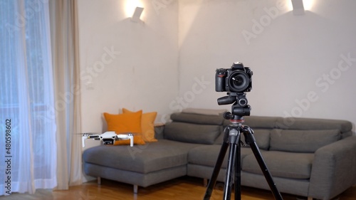 A photographer uses a drone for surveying, photography and video of apartment and building interiors - real estate and home staging for sell the home - new 4k aerial technology