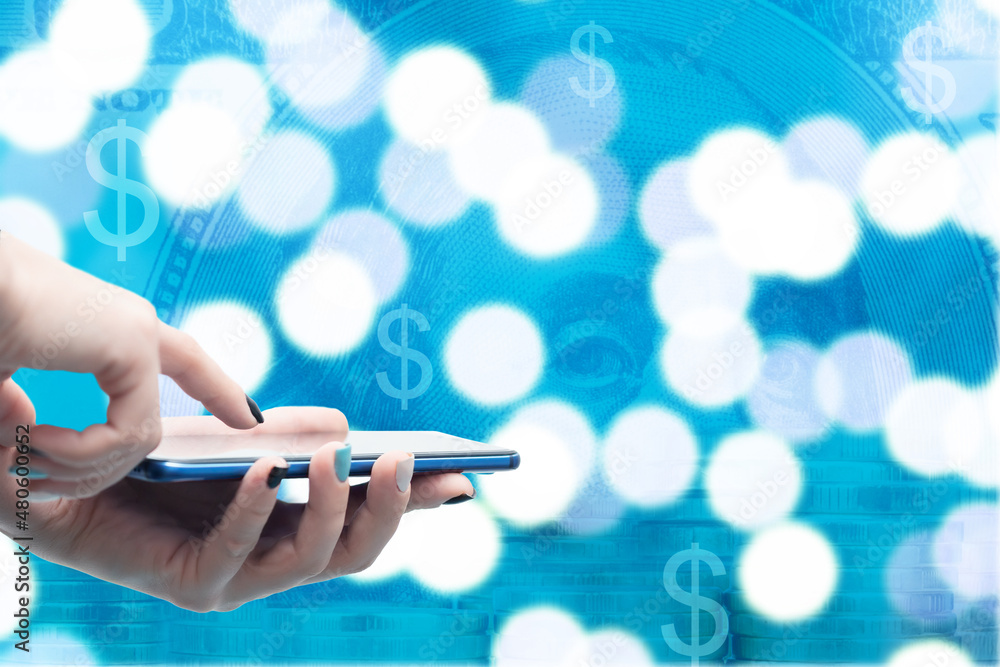 online banking phone app,smartphone in hand on the background of money dollars and coins, application for finance, deposits and loans, place for text online banking phone app,smartphone in hand on the background of money dollars and coins, application for finance, deposits and loans, place for text